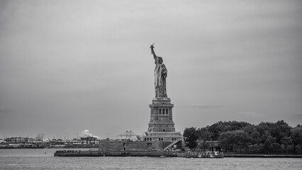Statue of Liberty and island across the harbor in black and white © Damien