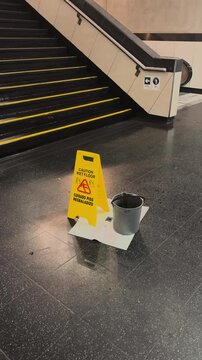Wet floor and caution sign during rainy weather