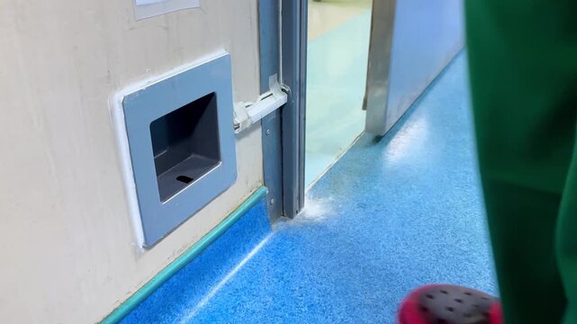 "No touch" sensor switch on the wall, using to open the door by passing hand on the sensor. Technology object.
