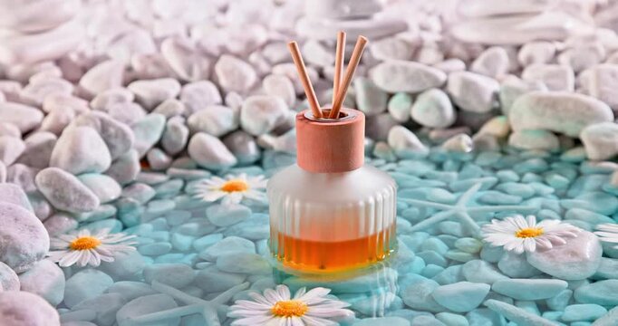 Sophisticated diffuser fragrance on the shore of sea ??white stones.