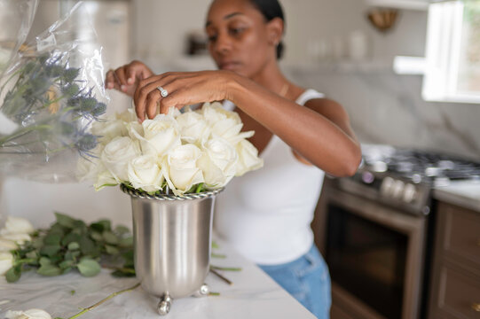 Preparing White Roses in a Kitchen Setting for a Special Occasion