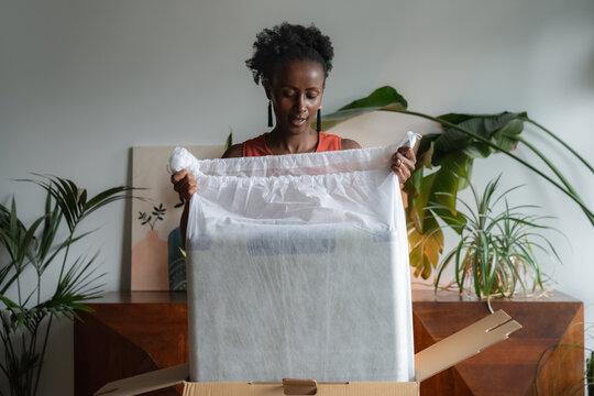 Woman unpacking suitcase while getting ready for vacation