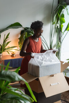 Woman unpacking her new suitcase she ordered online