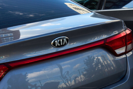 Tyumen, Russia - September 20, 2026: Kia badge and red taillight bar on grey car trunk