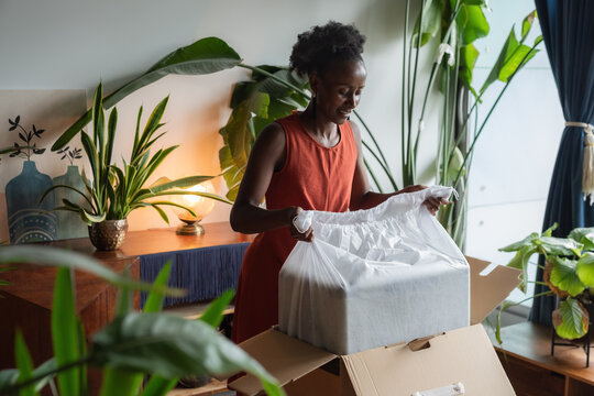 Woman taking her suitcase from box
