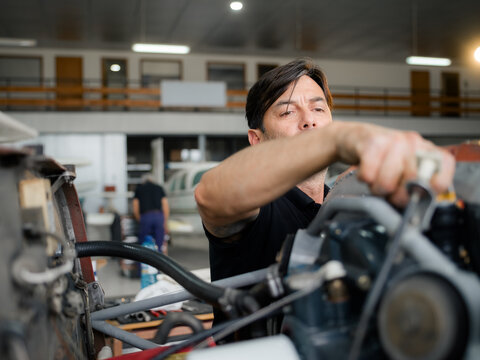 Mechanic is checking airplane engine oil level