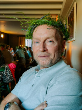 Portrait of a man at a solstice event wearing a flower crown