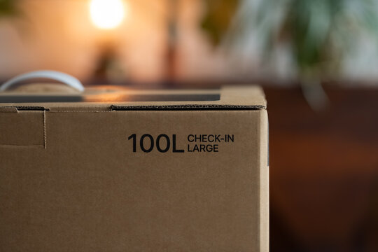 Box with brand new big suitcase