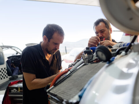 Mechanics focused on engine repairing