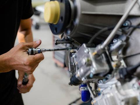 Mechanic Works on Aircraft Engine in a Repair Shop