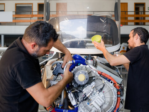 Mechanics working on airplane engine maintenance