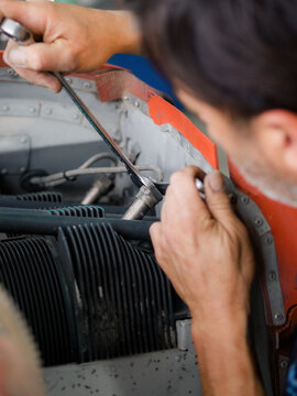 Mechanic repairing old engine