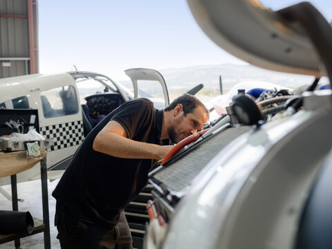Mechanic inspecting airplane engine