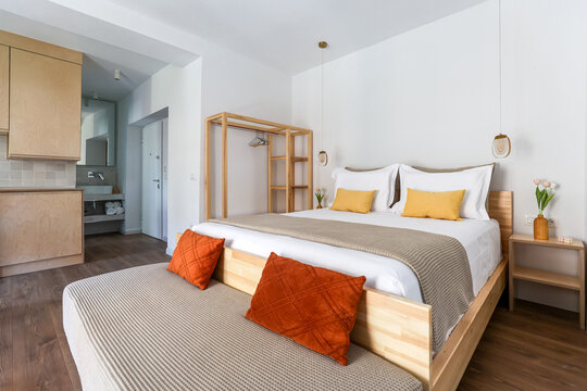 Double bed dressed in ochre and rust