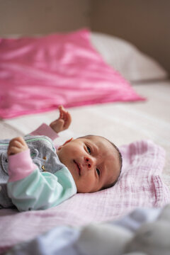 Newborn baby discovering surroundings on a soft bed