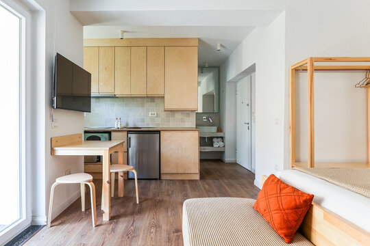 Compact studio kitchen opens onto a daybed