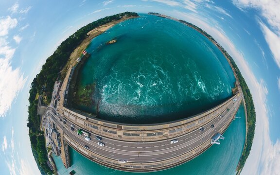 Tidal renewables - tiny planet of traffic crossing turbine barrage