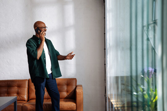 Casual Man Talking On Phone In Living Room