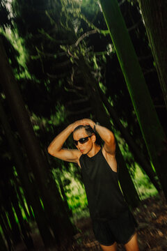 Runner takes a break in a Forest During the Day