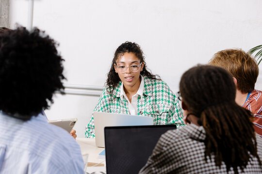 Creative professionals using laptops during the development of a board