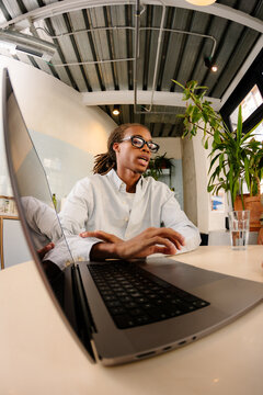 Black entrepreneur explaining a project to colleagues in a workspace.