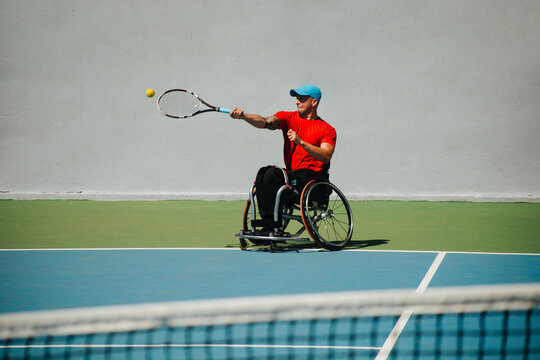 Wheelchair Tennis Athlete Playing Forehand On Court