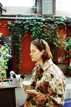 Woman having coffee outdoors