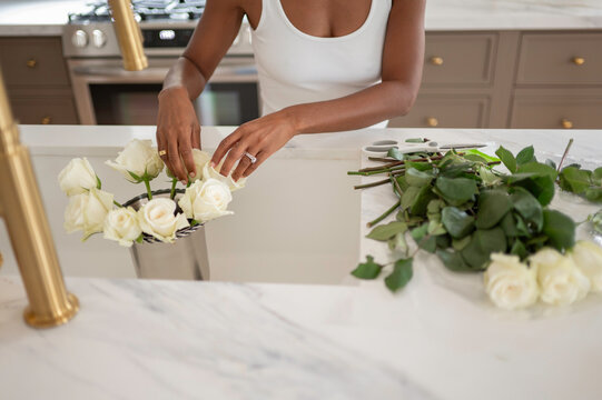 Creating a Floral Arrangement in a Kitchen With White Roses