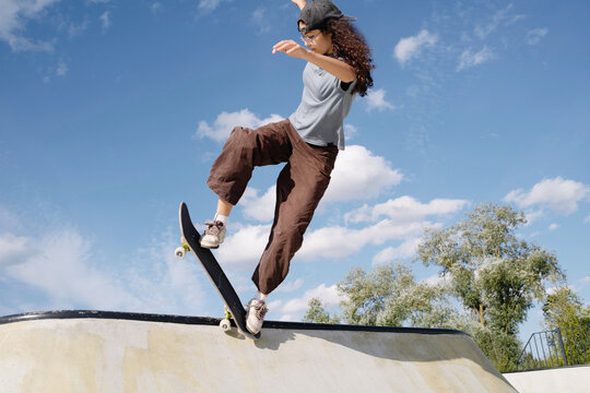 Skateboarder performs tricks at a skate park