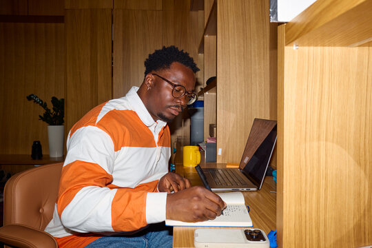 Man writes in his home study