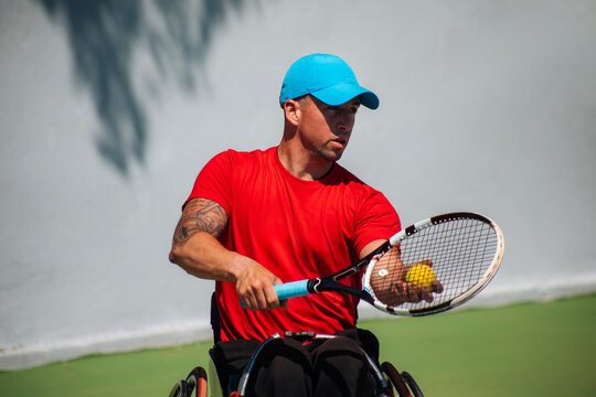 Wheelchair Tennis Athlete Hitting Ball During Match