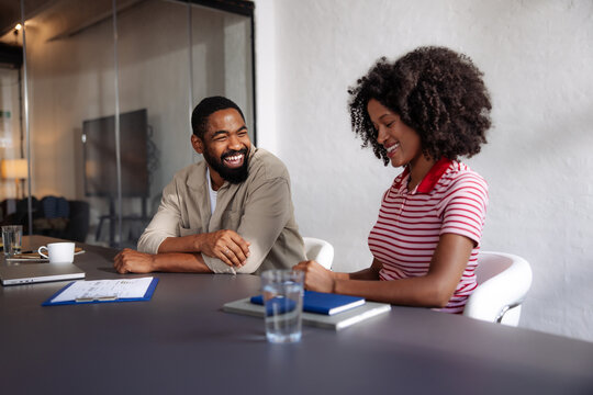 Smiling Colleagues in Casual Business Meeting at Office