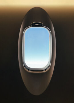 Airplane window view of sky during flight travel