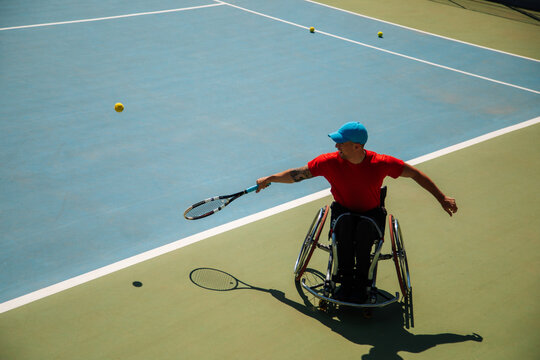 Adaptive Wheelchair Tennis Player Serving On Court