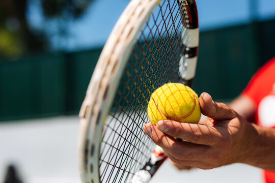 Close-Up Tennis Racket And Ball In Hand