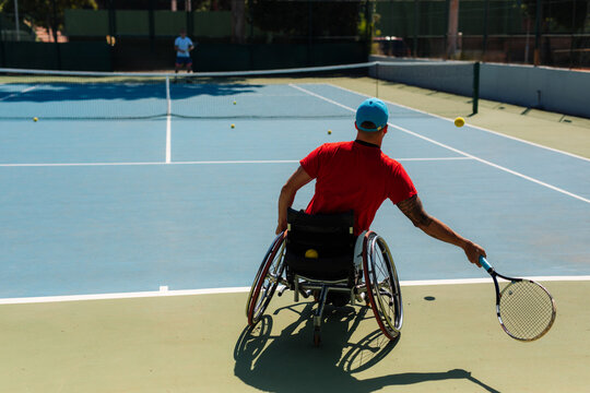 Wheelchair Tennis Player Hitting Forehand On Court