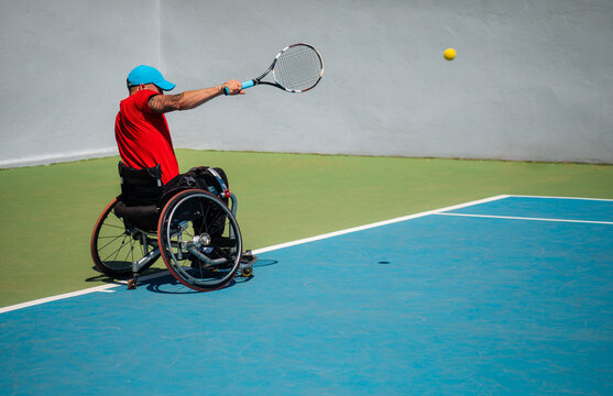 Wheelchair Tennis Player Serving on Outdoor Court