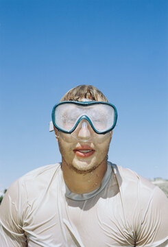 Person Wearing Wet Goggles at the Beach During a Sunny Day