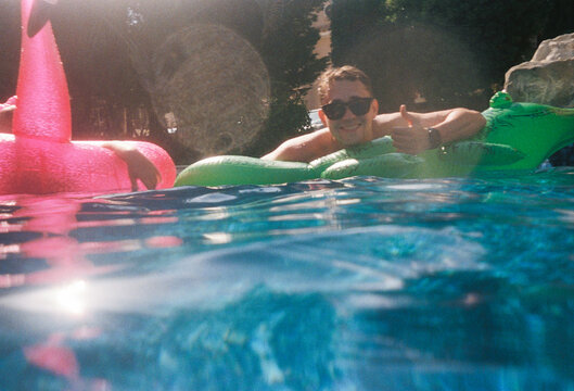 Person Enjoying Pool Time With Floaties in Summer Setting