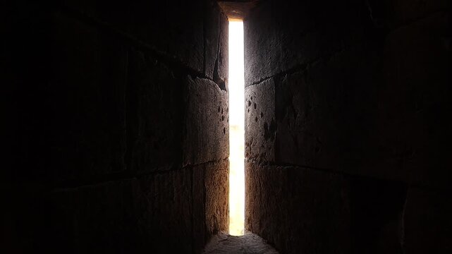 Ancient arrow slit inside a tower of Aleppo Citadel, Syria, overlooking the historic city and Syrian flag, showcasing medieval architecture, military heritage, tourism and cultural history.