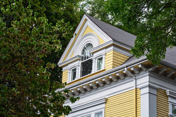 Yellow residential house facade with gabled wall dormer window in Boston © Baharlou