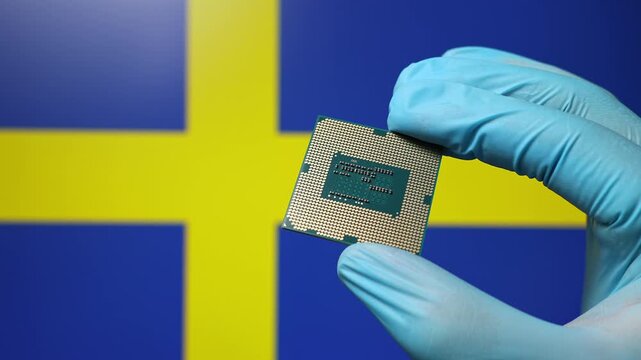 Close up view of hand in blue glove holding CPU microchip. Swedish flag in blurred background. Concept of semiconductor shortage and artificial intelligence development in Sweden.