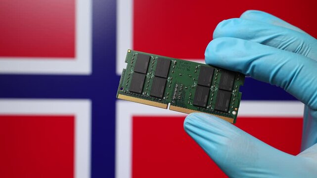 Close up view of hand in blue glove holding RAM memory microchip module. Norwegian flag in blurred background. Concept of semiconductor shortage, artificial intelligence development in Norway.