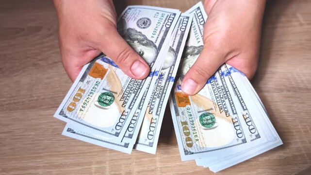 Close up video shows Hands counting money stack hundred dollar bills Finance Business concept American currency banking Personal savings wealth investment Business transactions planning 4K resolution