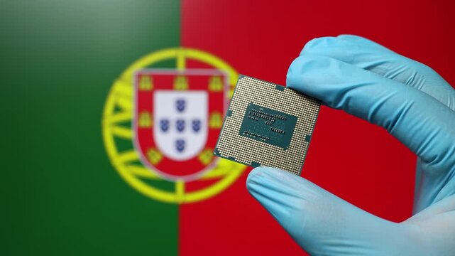 Close up view of hand in blue glove holding CPU microchip. Portuguese flag in blurred background. Concept of semiconductor shortage and artificial intelligence development in Portugal.
