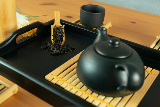 chinese tea ceremony gongfu tea set chahu teapot pinming cups chaban tray, front view on wooden table with gray background and copy space for banner design concept of tea culture, restaurant