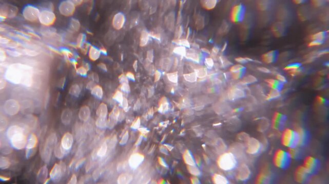 Defocused crystal glare. Bokeh light. Silver green blue color lens flare glitter rainbow leaking on illuminated creative optical abstract background.