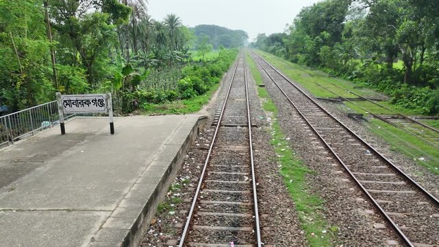 Close-Up Perspective of Parallel Steel Railway Tracks in a Rural Environment