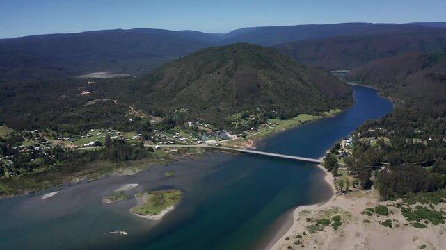 Aerial view of an estuary bridge and coastal settlement near Corral, Chile