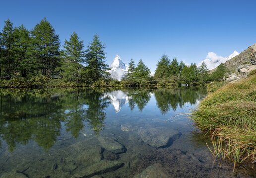 Snow-covered Matterhorn reflected in the lake, Lake Grindij, Zermatt, Wallis, Switzerland